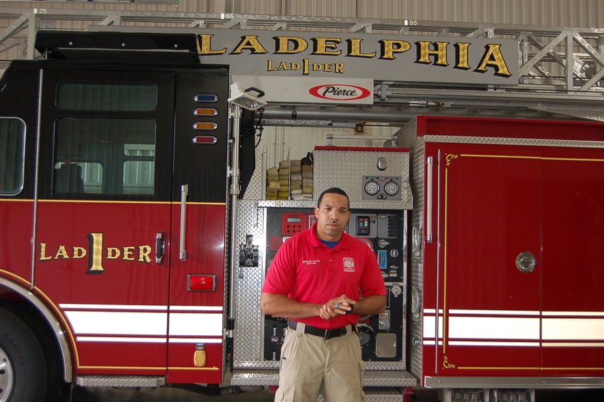 Philadelphia Fire Department Capt. Nicholas Alexander Walker stands in front of the city’s Ladder 1. Walker, who was homeless more than a decade ago, said that finding a Bible in a dumpster changed his life and put him on a new path.